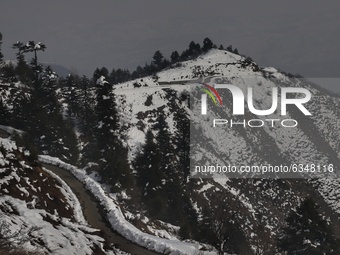 A vehicle moves through a road in snow covered area of Baramulla Jammu and Kashmir India on 14 January 2021 (