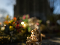 Figurines and flowers seen at the memorial commemorating more than 200 children from Bethany Mother and Child Home at Mount Jerome Cemetery...