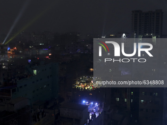 People set up party lights on a rooftop to celebrate Sakrain festival in Dhaka, Bangladesh on Thursday, January 14, 2021. (