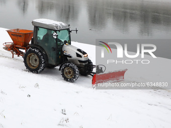 A snow plough is cleaning Vistula boulevards covered with snow in Krakow, Poland. January 14, 2021.  (