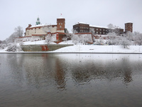 A view over Vistual River and Wawel Castle covered with snow in Krakow, Poland. January 14, 2021. (