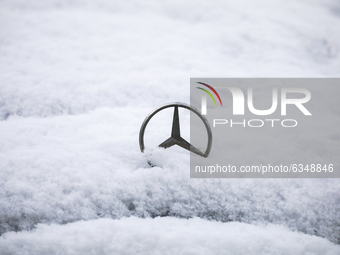 Mercedes Benz car emblem is covered with snow in Krakow, Poland. January 14, 2021.  (