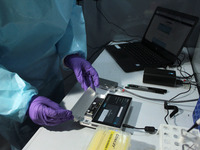 A healthcare worker in PPE shows the process of Genome Sequencing at SpiceHealth's laboratory for all positive samples (Covid-19) from inter...