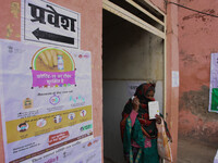 A health worker woman Shows her vaccination record card after get vaccinated,  at a hospital  in the outskirts of Allahabad on January 16,20...