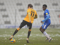 Cambridges Harrison Dunk and Colchesters Kwame Poku during the Sky Bet League 2 match between Colchester United and Cambridge United at the...