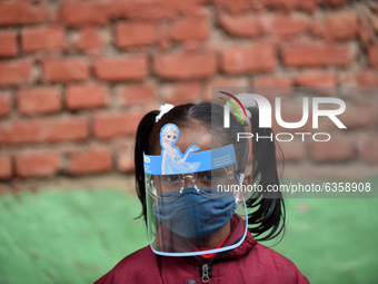 A Portrait of School student along with face mask and shield before entering classes due to COVID-19 pandemic fear at Kirtipur, Kathmandu, N...
