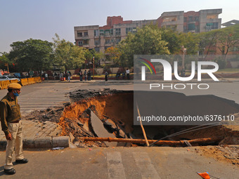  A sinkhole after a portion of a road collapsed at Chomu Circle, in Jaipur, Rajasthan,India, Saturday, Jan. 23, 2021.(