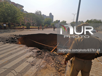  A sinkhole after a portion of a road collapsed at Chomu Circle, in Jaipur, Rajasthan,India, Saturday, Jan. 23, 2021.(
