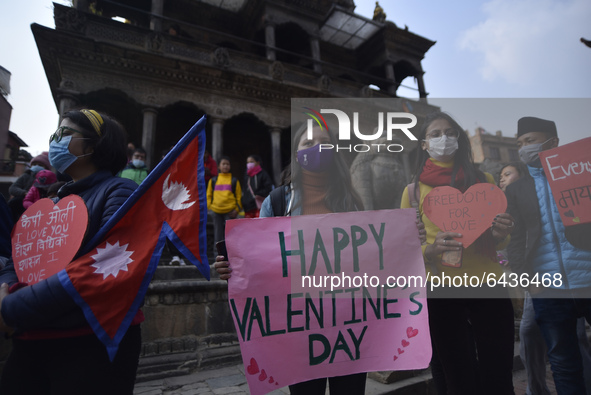 Nepalese people hold placard along with love slogans during Valentine’s Day program in Patan Durbar Square, Lalitpur, Nepal on Sunday, Febru...