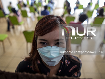  A health worker posed for a picture in waiting line for the vaccination. 2nd Phase of Vaccination covid19 for health worker in Indonesia he...