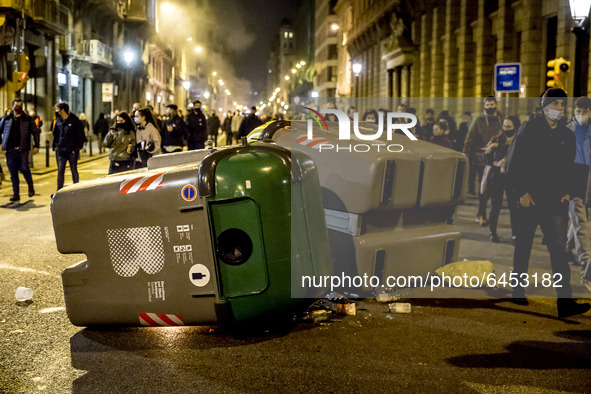 People clash with riot police during a demonstration against the imprisonment of rapper Pablo Hasel, in Barcelona, Spain, on February 19, 20...