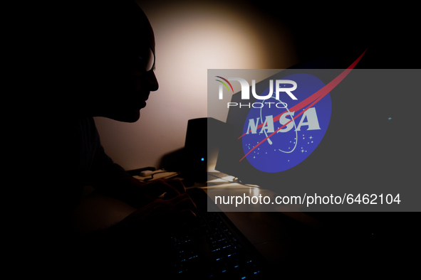 A man looks at a computer screen with a Facebook logo in Warsaw, Poland on February 21, 2021. NASA will air live coverage of spacewalks from...