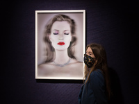 A gallery staff member stands next to 'Kate Moss She's Light (Pure)', 2014, 3D print by Chris Levine (est. £20,000-30,000) donated by both L...