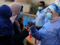 Health workers receive patients in a United Nations-run clinic amid the coronavirus disease (COVID-19) outbreak, in Gaza City February 24, 2...