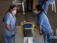 Nurses wait for hospital workers who are scheduled to receive the Sinovac COVID19 vaccine during a ceremonial vaccination program held insid...