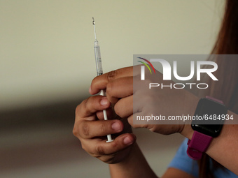 A nurse prepares to administer the Sinovac COVID19 vaccine during a ceremonial vaccination program held inside a sports stadium in Marikina...
