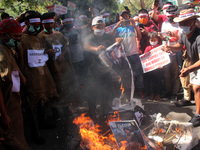 Chin refugees from Myanmar shout slogans as they burn symbolic coffins of Myanmar's Commander in chief, Senior General Min Aung Hlaing and C...