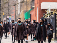 Students of Notre Dame secondary school walk out from the building after the first day at school  in southern London as schools in England r...