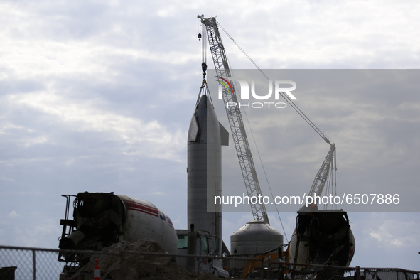 SpaceX’S new Starship SN-11 still attached to the crane after being moved to the launch pad for testing in Boca Chica, Texas on the afternoo...