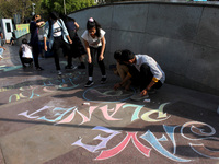 Activists participate in a street art campaign to raise awareness on climate change, at Connaught Place in New Delhi, India on March 14, 202...