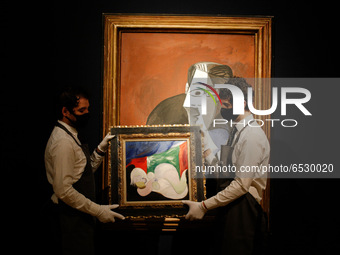 Members of staff pose holding oil on canvas work 'Femme nue couchee au collier (Marie-Thérèse)', by Pablo Picasso, estimated at GBP9,000,000...