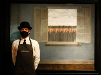 A member of staff poses with oil on canvas work 'Le mois des vendanges', by Rene Magritte, estimated at GBP10,000,000-15,000,000, during a p...