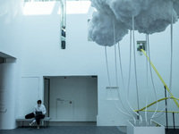 Artist Keith Lam uses his computer as he sits next to his art piece ‘ Landscape of the cloud (2013-2021) ‘ inside the ‘Not a Fashion Store’...
