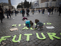 Children put signs on the ground as Fridays For Future activists demonstrate in Piazza del Popolo in Rome,  on March 19, 2021. Dozens of act...