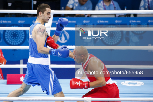Valentino Manfredonia  of Italy (red) and Teymur
Mammadov of Azerbaijan (blue) compete for the gold medal in the Men's Boxing Light Heavywei...
