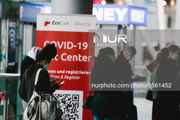 people wait in front of coronavirus test center at Duessedorf airport, Germany on March 26, 2021 as airlines adds more flights to cope with...