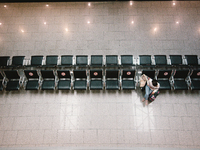 a traveller sits a chair at Duessedorf airport, Germany on March 26, 2021 as airlines adds more flights to cope with surge in demand (