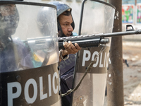 A riot police shots as activists from Islamist groups clash with the police during a protest against the visit of Indian Prime Minister Modi...