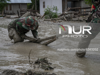 Soldiers cleaned up the remaining mud that hit a house in Beka Village, Marawola District, Sigi Regency, Central Sulawesi Province, Indonesi...