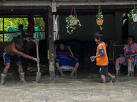 Residents clean up the remaining mud that inundated their houses in Beka Village, Marawola District, Sigi Regency, Central Sulawesi Province...