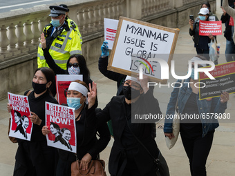 LONDON, UNITED KINGDOM - MARCH 31, 2021: Demonstrators march through central London to the Chinese Embassy in a protest against the military...