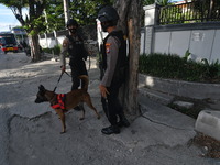 Police inspect a church yard using sniffer dogs in Palu, Central Sulawesi, Indonesia, Thursday (1/4/2021). The government has tightened and...