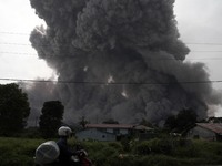 Mount Sinabung spews pyroclastic flows into the sky that threatened houses abandoned, as seen from the village of Gamber, North Sumatra, Ind...