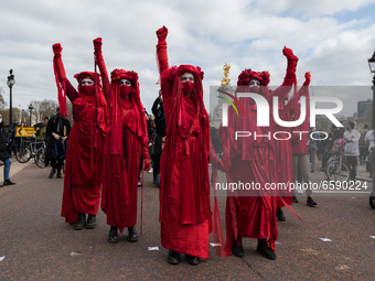 LONDON, UNITED KINGDOM - APRIL 03, 2021: Extinction Rebellion's Red Brigade take part in a protest march through central London against gove...