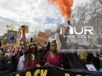 LONDON, UNITED KINGDOM - APRIL 03, 2021: Demonstrators set off flares as they march through central London in a protest against government’s...