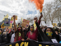LONDON, UNITED KINGDOM - APRIL 03, 2021: Demonstrators set off flares as they march through central London in a protest against government’s...