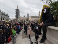 LONDON, UNITED KINGDOM - APRIL 03, 2021: A demonstrator wearing Guy Fawkes mask attends a rally in Parliament Square during a protest agains...