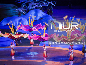 The dancers giant flowers  acting around the Ateshgah fire temple rised from the Main stage    during  the  Closing Ceremony of the inaugura...
