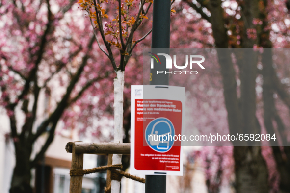 mask wearing sign is seen in the historical district in Bonn, Germany on April 04, 2021 