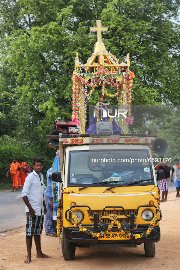 Man stands by a vehicle carrying a statue of the Virgin Mary as thousands of Indian Catholics embark on the pilgrimage and walk to the Annai...