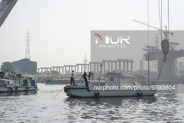 A rescue team trying to recover a capsized boat in Shitalakshya River, in Narayanganj on April 5, 2021. 