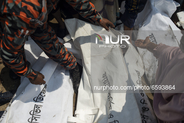 A woman identifies the dead body of his relative who got killed in the boat crush at Shitalakshya River, in Narayanganj on April 5, 2021. 