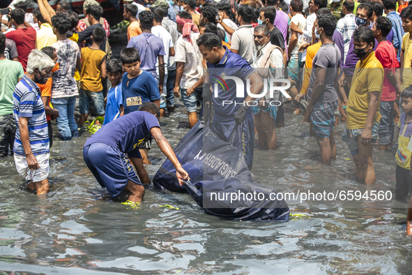 Rescue workers carry a body recovered from a ferry named ML Sabit Al Hasan that collided with a cargo vessel and sank on Sunday in the Shita...