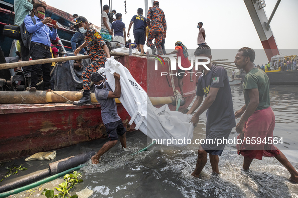 Rescue workers carry a body recovered from a ferry named ML Sabit Al Hasan that collided with a cargo vessel and sank on Sunday in the Shita...