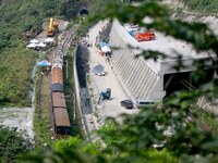 Views of the damaged train carriages being lifted and removed from tracks after it derailed in a tunnel in Hualien, Taiwan, 3 April 2021, le...