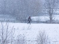 People outside in the snow. The Netherlands wakes up snow covered after an intense morning snowfall, a bizzar event for April. The second da...